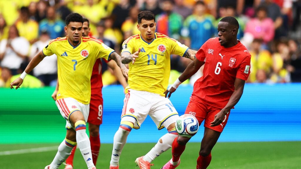 Luis Díaz y Gustavo Puerta luchando un balón con Denis Zakaria