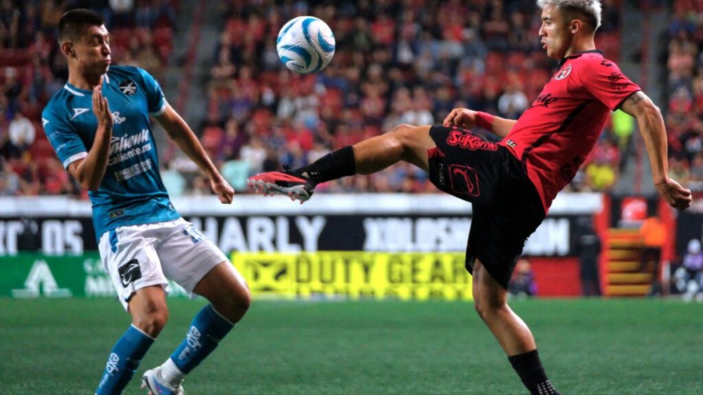 Jugadores de Xolos y Mazatlán disputan el balón en partido de futbol