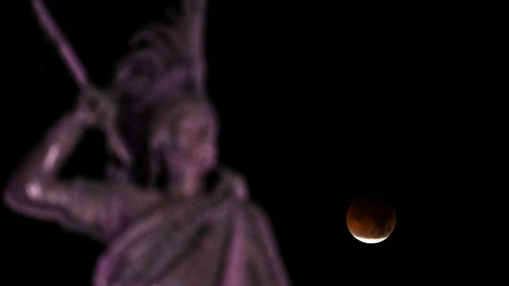 La "Luna de Sangre" y al fondo el Monumento a Cuauhtémoc, en la Ciudad de México.